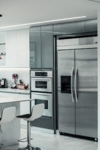 Kitchen with stainless steel appliances including a refrigerator and double oven
