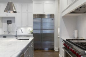 Stainless steel refrigerator in a white kitchen