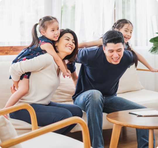 parents and two children playing in their home